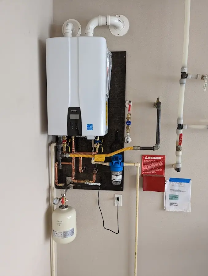 Professional plumber installing copper piping in a Hampton home